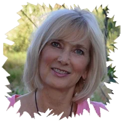 Outdoor portrait of wellness expert and author Candia Lea Cole smiling with a jagged border.